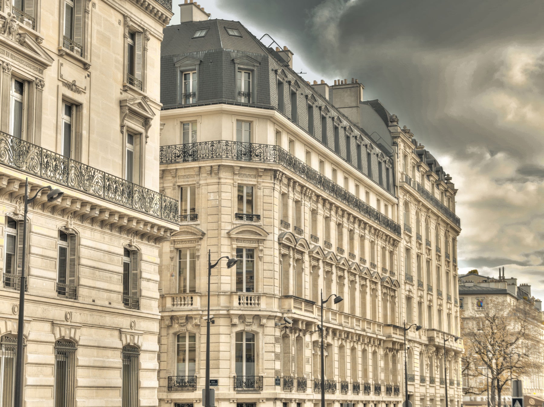 Parisian Facades wall mural fills the dining room with stormy old world city character.