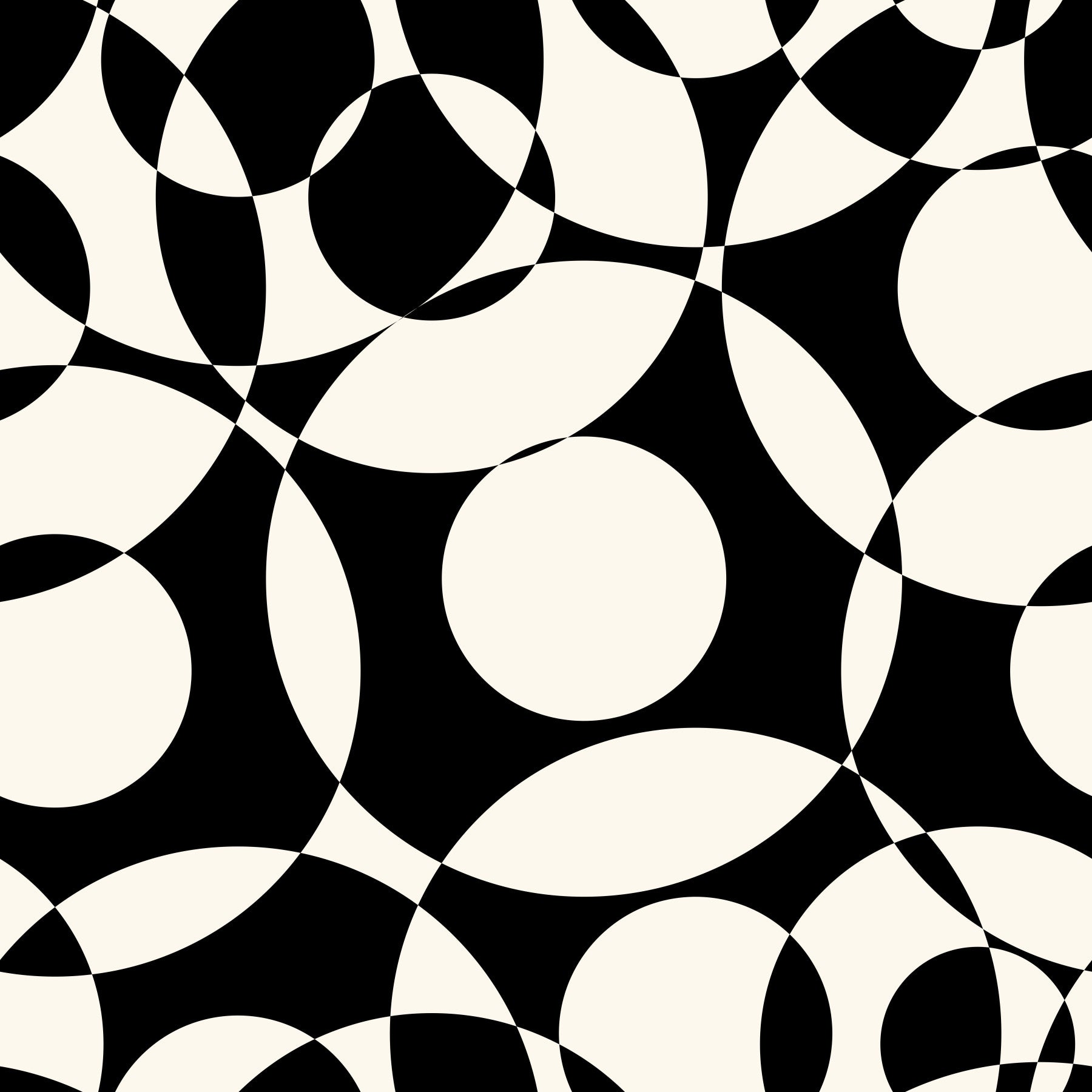 Monochrome circles wallpaper behind a beige sofa in a wood-shelved living room GD12497