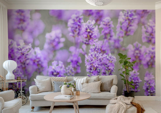 Lavender Farm wallpaper mural of close-up purple lavender blooms behind a beige sofa and cushions in a bright living room