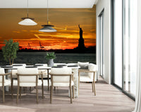 Ocean water reflecting golden Liberty Sunset backdrop wallpaper.