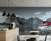 Nordic landscape wall mural with steep mountains and a cozy red cabin perched along the fjord’s edge.