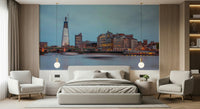 London Luminescence wallpaper mural of The Shard and Thames skyline at dusk behind a grey bed and armchairs in a bedroom