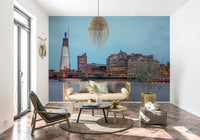 London Luminescence wallpaper mural of the Thames skyline behind a rattan sofa and olive tree on terracotta tile