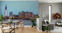 London Luminescence wallpaper mural of dusk over London behind a black dining table and grey sofa living space