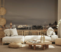 London's Nightfall wallpaper mural of Big Ben at dusk behind cream low sofas and a round wood table in a living room