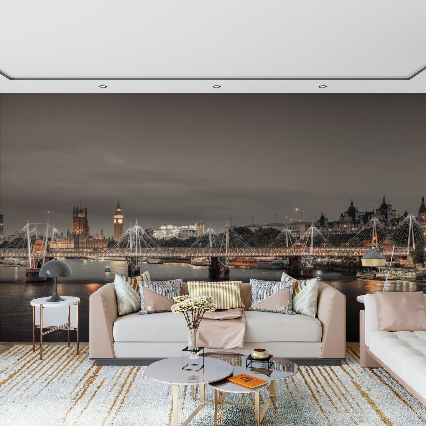 London's Nightfall wallpaper mural of the glowing London skyline behind a blush sofa and round marble tables