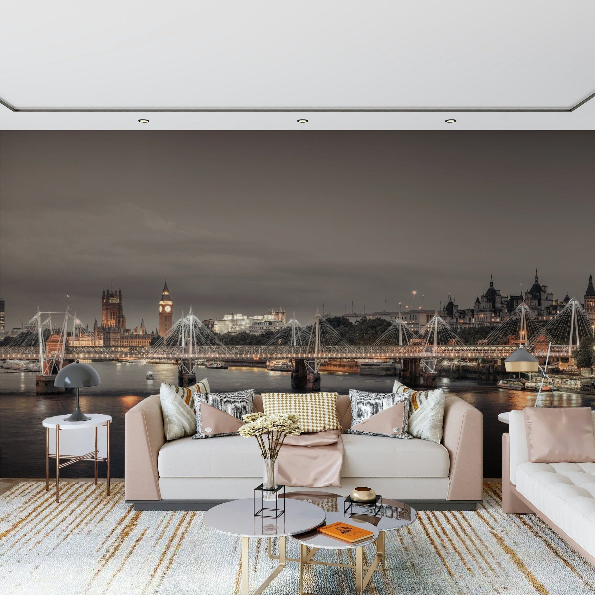 London's Nightfall wallpaper mural of the glowing London skyline behind a blush sofa and round marble tables