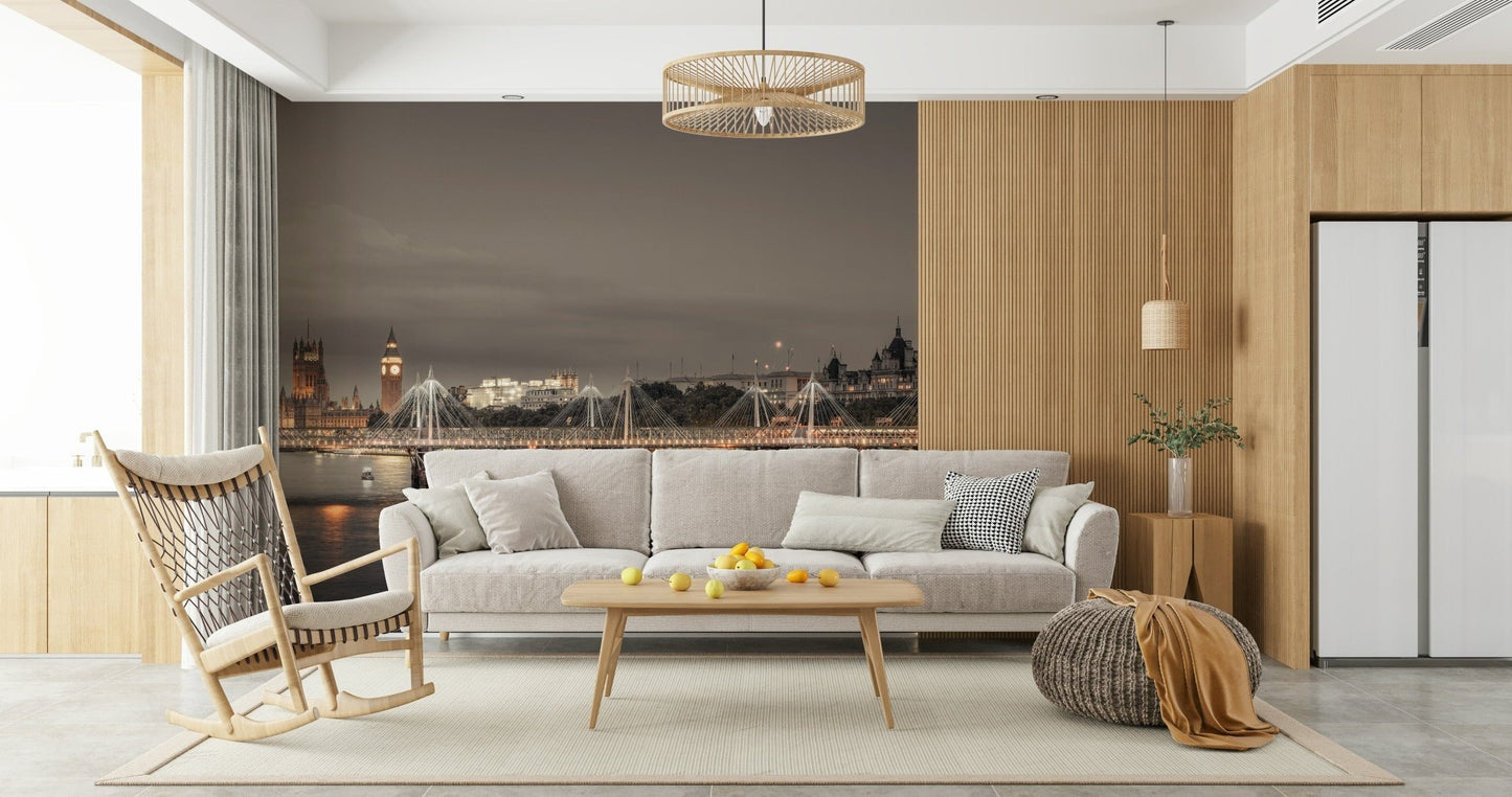 London's Nightfall wallpaper mural showing Big Ben at twilight behind a grey sofa and wood rocking chair in a living room