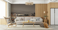 London's Nightfall wallpaper mural showing Big Ben at twilight behind a grey sofa and wood rocking chair in a living room