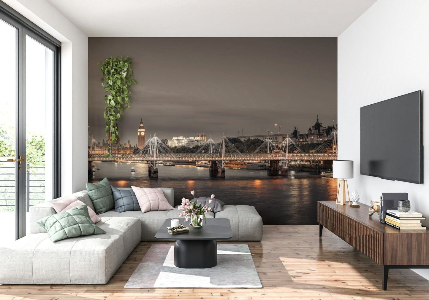 London's Nightfall wallpaper mural of the dusk Thames behind a grey sectional and wall-mounted TV in a living room
