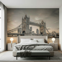 London's Tower Bridge wallpaper mural in sepia behind a beige bed with globe lamps in a bedroom