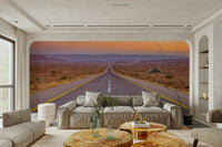 Long desert highway with yellow lines leading to a distant horizon mural.


