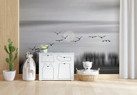 Wall mural with a tranquil moonlit scene and birds in graceful flight.