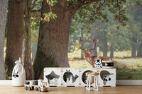 A contemporary living room with a large forest wall mural.

