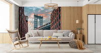 Manhattan Bridge Vista wallpaper mural of the bridge and brick lofts behind a cream sofa and wood rocking chair