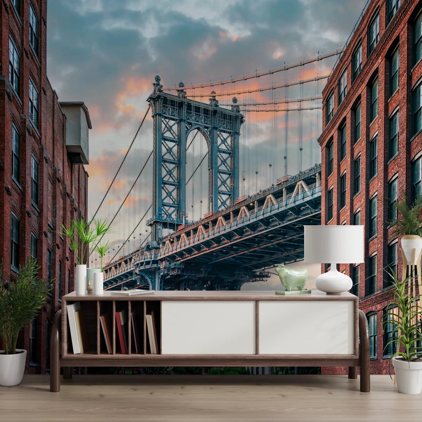 Manhattan Bridge Vista wallpaper mural of the blue bridge and brick buildings above a wood sideboard and lamp