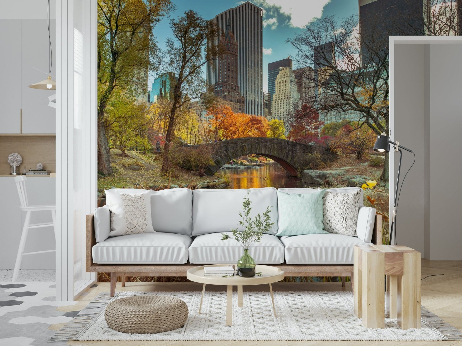 Manhattan's Autumn Embrace wallpaper mural of an autumn park and skyline behind a white sofa in a living room