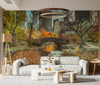 Manhattan's Autumn Embrace wallpaper mural of Central Park in fall behind a white sofa and wood-ring chandelier