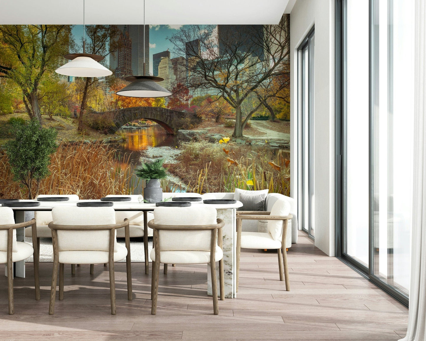 Manhattan's Autumn Embrace wallpaper mural of Central Park in fall behind a marble dining table and cream chairs
