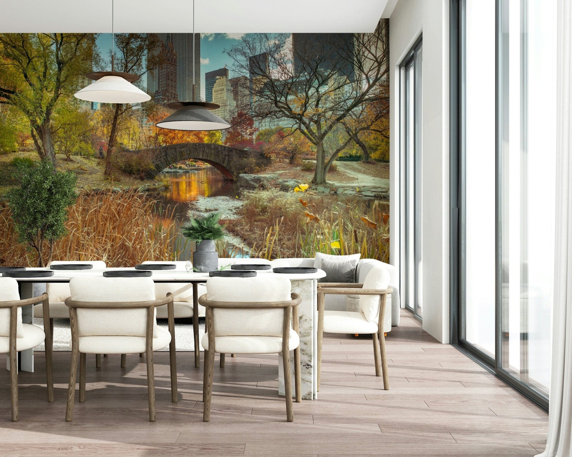 Manhattan's Autumn Embrace wallpaper mural of Central Park in fall behind a marble dining table and cream chairs