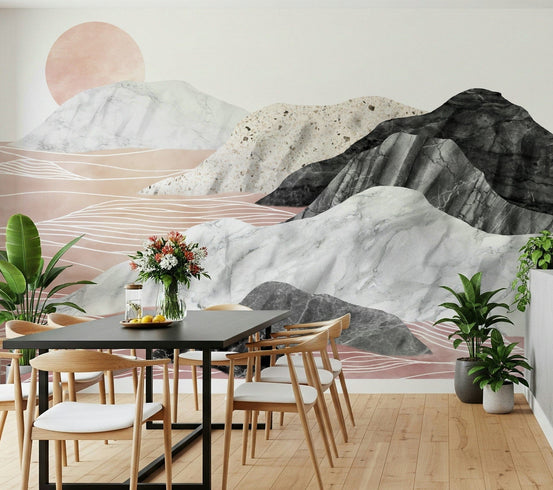 Marble Peaks Sunset wallpaper mural with pink and grey marble mountains behind a black dining table and wood chairs