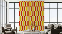 Marigold and Maple wallpaper feature wall behind a beige sofa in a bright window-lined living room
