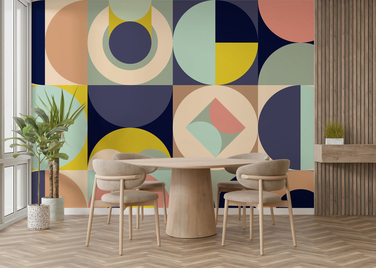 Mescolanza Alt V3 wallpaper mural in sage, peach and navy shapes behind a light wood round dining table and chairs