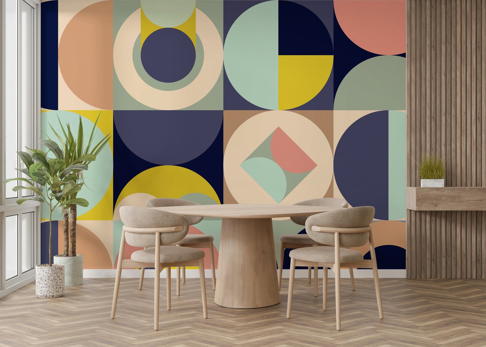 Mescolanza Alt V3 wallpaper mural in sage, peach and navy shapes behind a light wood round dining table and chairs