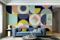 Mescolanza Alt V3 wallpaper mural of geometric circles behind a blue tufted Chesterfield sofa with gold ring pendants