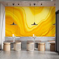 Metallic yellow Color flow wallpaper mural as a feature wall in a home office workspace in yellow tones