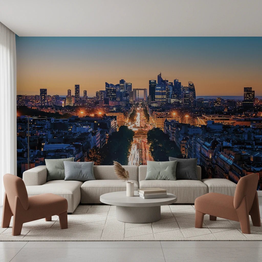 Metropolis Dusk wallpaper mural of skyscrapers and car-light trails behind a beige sectional and rust armchairs