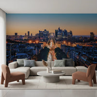 Metropolis Dusk wallpaper mural of skyscrapers and car-light trails behind a beige sectional and rust armchairs