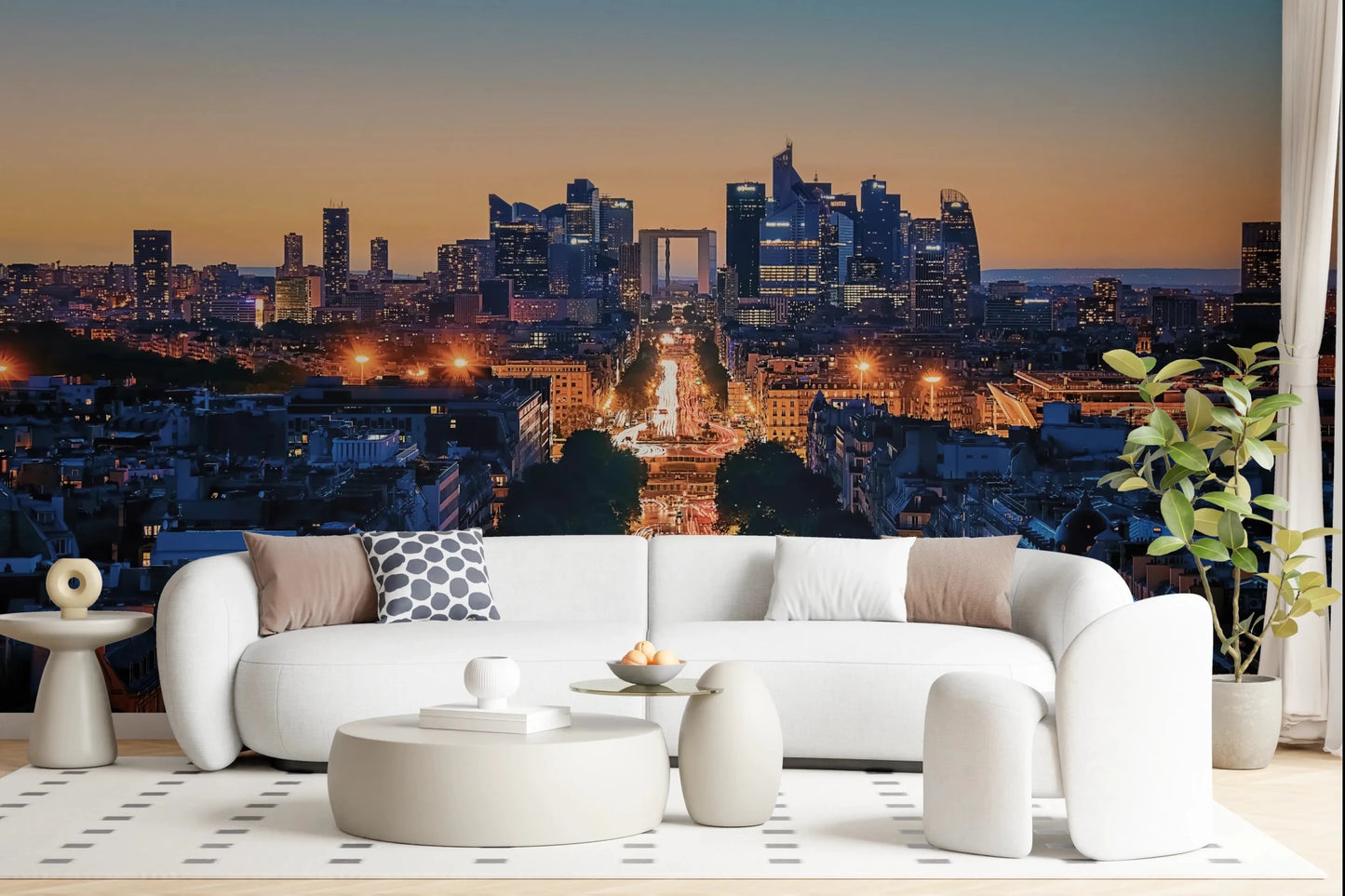 Metropolis Dusk wallpaper mural of the lit city skyline at dusk behind a curved white boucle sofa in a living room