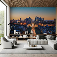 Metropolis Dusk wallpaper mural of a dusk city skyline behind a grey sofa under a wood-slat ceiling in a living room