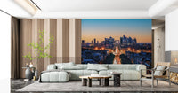 Metropolis Dusk wallpaper mural of the La Defense skyline behind a mint green sofa and wood-slat living room wall