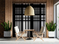Minimal Black & White Stripes wall mural on a wood-panel wall behind two cream armchairs under a rattan pendant