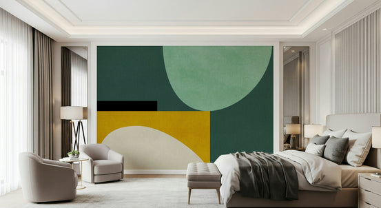 Minimalist Curves wallpaper mural in green and yellow in a bedroom with a gray bed and beige armchairs