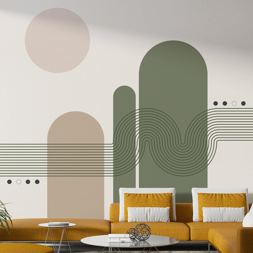 Minimalist Desert Vibes wallpaper mural with green and beige arches behind a mustard yellow sofa in a living room