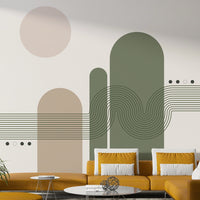 Minimalist Desert Vibes wallpaper mural with green and beige arches behind a mustard yellow sofa in a living room