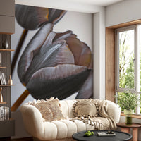Miracle Tulips wall mural of moody tulip petals behind a cream curved sofa with a pom-pom cushion and knit throw