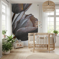 Miracle Tulips wall mural of dusky tulip blooms in a nursery with a round wood crib, rattan pendant and green plants