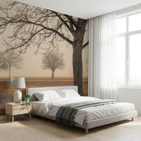 Misty Countryside wallpaper mural of bare trees in morning mist behind an upholstered bed in a bright bedroom