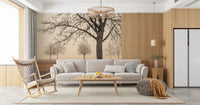 Misty Countryside wallpaper mural of foggy trees behind a grey sofa and wood rocking chair in a sunlit living room