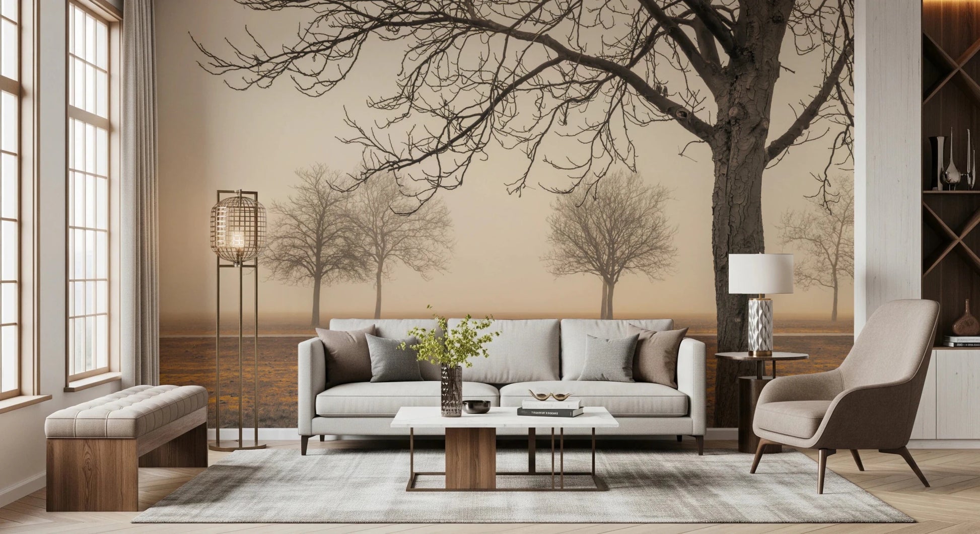 Misty Countryside wallpaper mural of hazy bare trees above a beige sofa and brown armchair in a warm living room