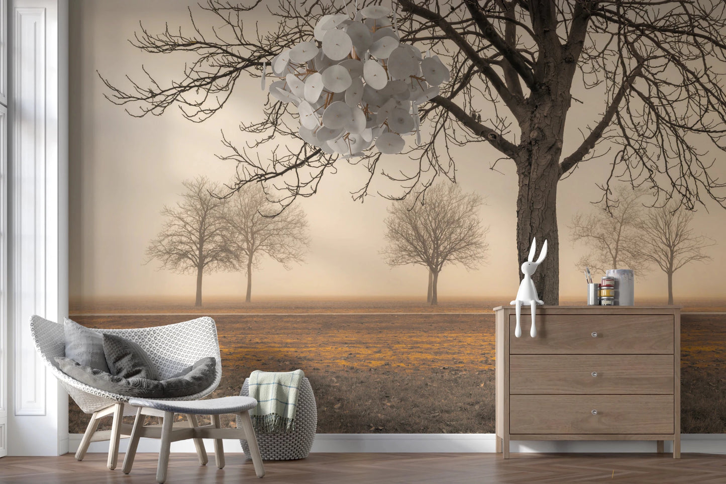 Misty Countryside wallpaper mural of bare trees in mist behind a white wicker chair and wood dresser in a reading nook