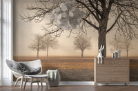 Misty Countryside wallpaper mural of bare trees in mist behind a white wicker chair and wood dresser in a reading nook