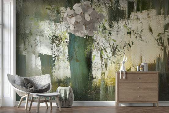 Misty Woodland Abstraction wallpaper mural in green and cream behind a white knit chair and wood dresser in a lounge