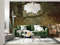 Filtered Light wallpaper mural of an olive grassland scene behind a green velvet sofa and white pendant lamp