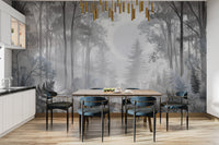 Misty Monochrome Forest wall mural in grey behind a wooden dining table and blue velvet chairs in a kitchen diner