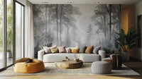 Misty Monochrome Forest wall mural in grey behind a curved cream sofa with a mustard pouf in a bright living room